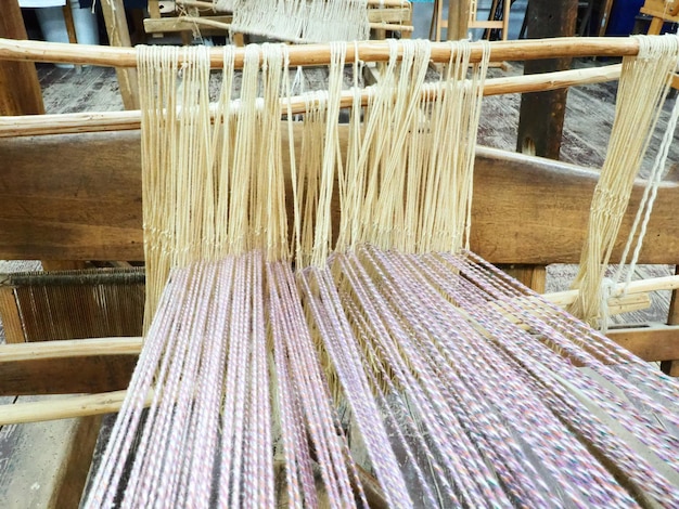 Photo loom and threads antique equipment for the production of carpets clothing and woven household items threads and yarns are pulled over bushings and slats trsic loznica serbia ethno tourism