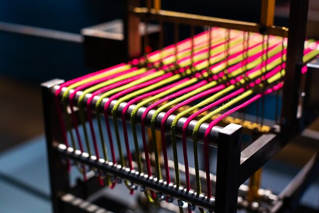 Looms, accessories, woven scarves, colored threads close up.