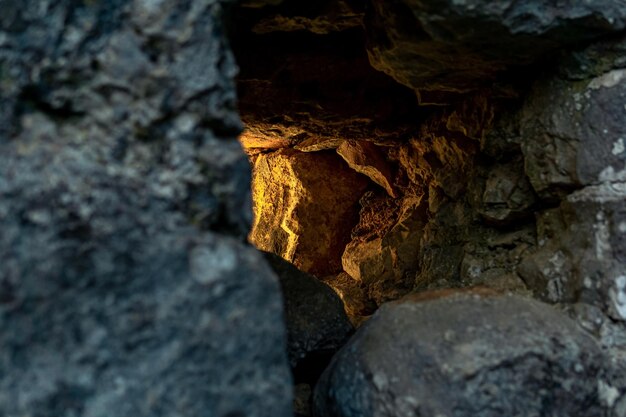 Loophole in the ancient fortress wall through which light breaks, close-up