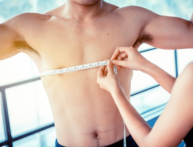 Photo loose belly fat and slender, waist measurement by using measuring tape. mind-body improvements and firm body.