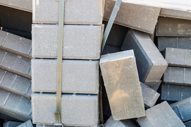 Loose paving slabs prepared for laying at the construction site Laying paving slabs in the pedestrian zone of the city Paving slabs and curbs