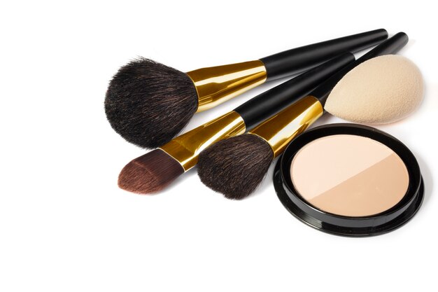 Loose powder, various makeup brushes. Makeup artist accessories isolated. Products for perfect facial skin makeup.