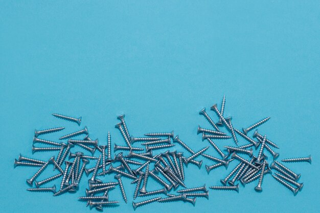 Loose screws on a blue background