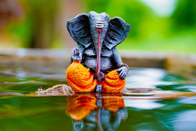 Lord ganesha sculpture on nature background