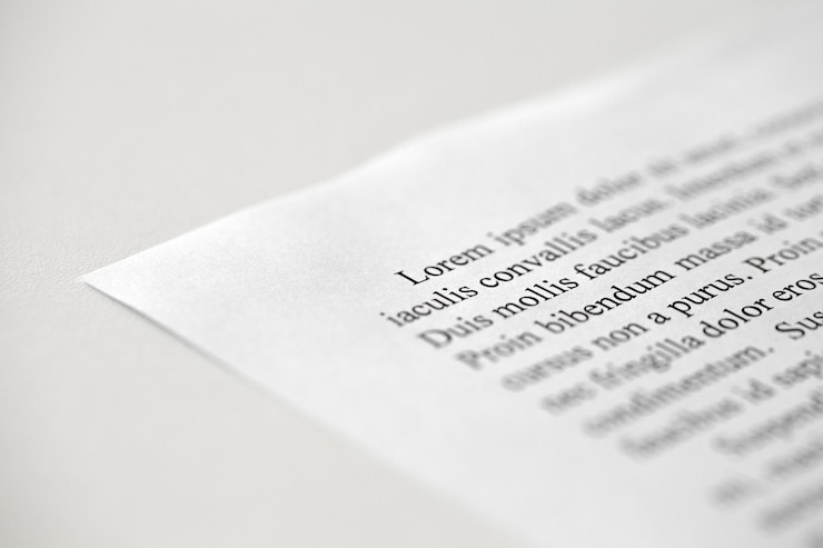 Photo lorem ipsum dolor text on printed on paper in black and white sample of document side view selective focus