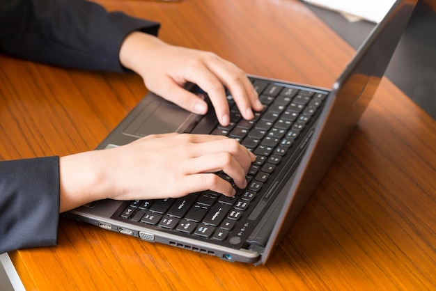 loseup A female employee works on a laptop