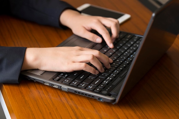 loseup A female employee works on a laptop