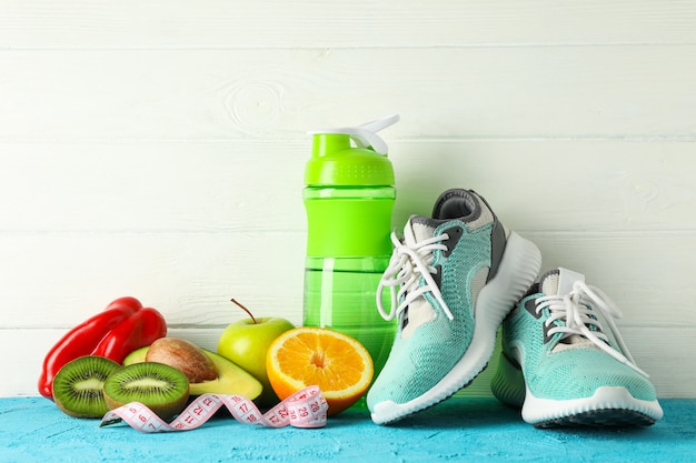 Loss weight accessories on color table against white wooden background