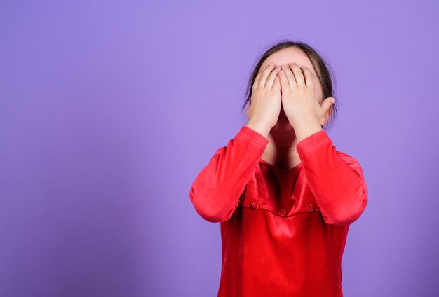 Lost emotional control Girl little child emotional face expression Almost mad Unleashed emotions concept Desperate baby Emotional face small girl violet background Can not stop her feelings