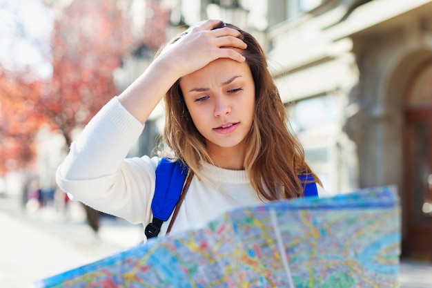 Lost tourist looking at city map on a trip. Looking for directions.