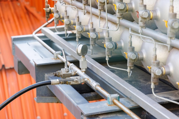 A lot of bottles filled with gas or gasoline are stacked in piles