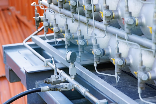 A lot of bottles filled with gas or gasoline are stacked in piles