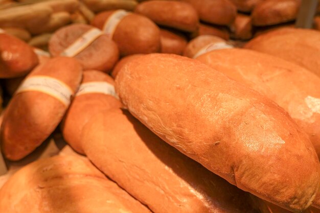 A lot of breads with a golden crust in the tray