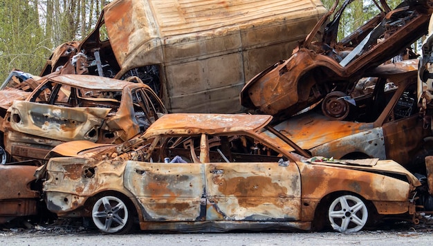 A lot of burnt fired cars in the parking lot the consequences of the invasion of Ukraine