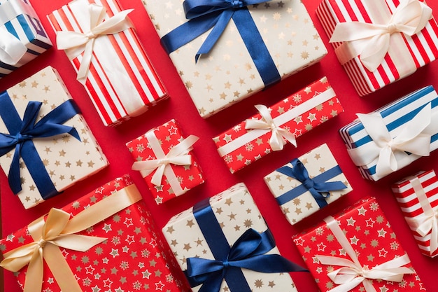 A lot of Christmas gift boxes in colored paper decorated on table, Top view close up. Many present New Year gift