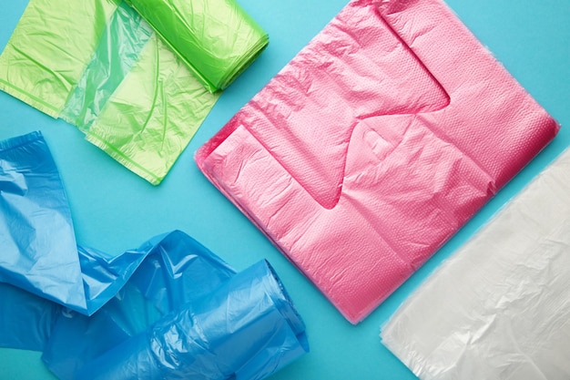 A lot of colored plastic bags rolls on a blue background