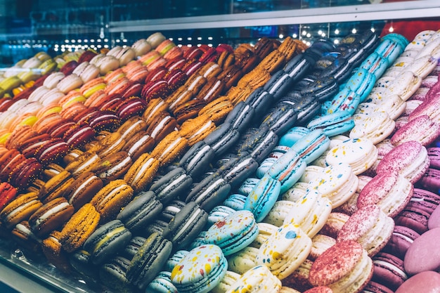 A lot of colorful macaroons on the candy shop.