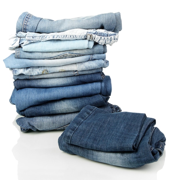 lot of different blue jeans isolated on white