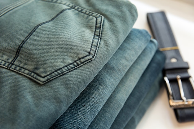 A lot of different blue jeans in the shop. Denim clothes store