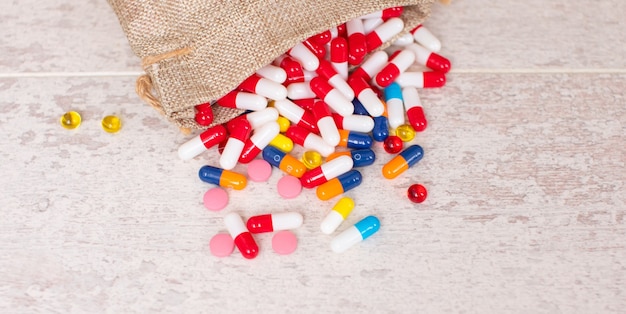 A lot of different colourful pills on a table background