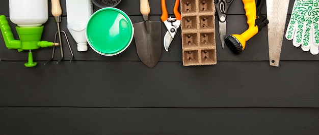 A lot of different garden equipment on the wooden table