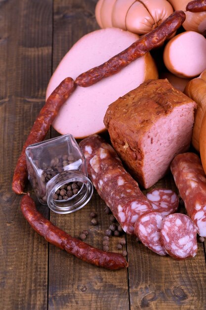 Lot of different sausages on wooden table closeup