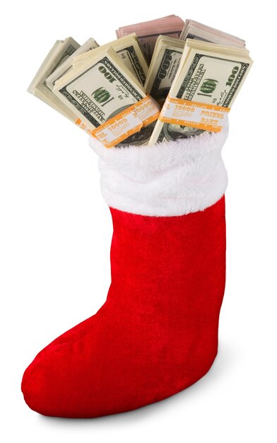 Lot of dollars in a Christmas sock on background