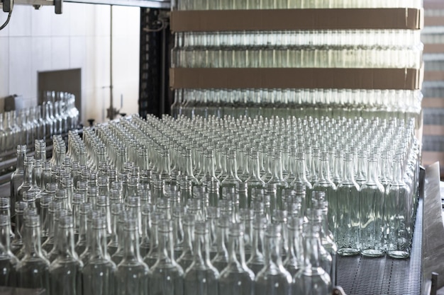 A lot of empty glass bottles on the conveyor