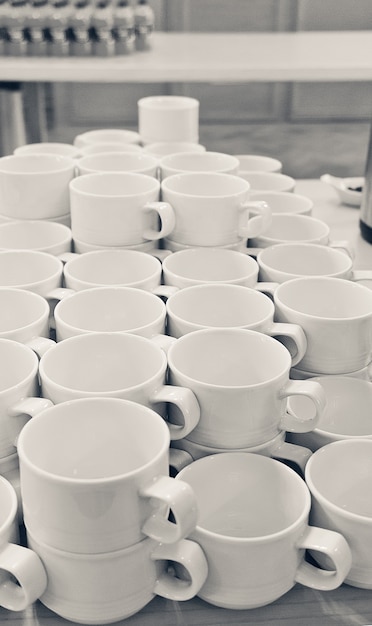 A lot of empty white porcelain cups on the table