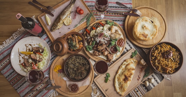 A lot of food on the wooden table. Georgian cuisine . Khinkali and Georgian dishes