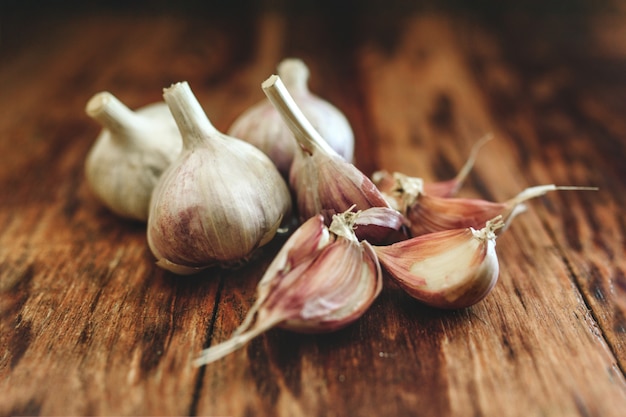 A lot of garlic on a wooden table.