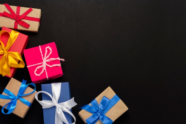 A lot of gift boxes on a black background. 