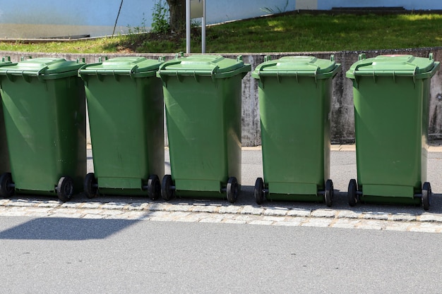 Lot of green garbage cans on the street