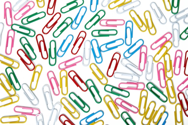 A lot of multi-colored colored paper clips background.