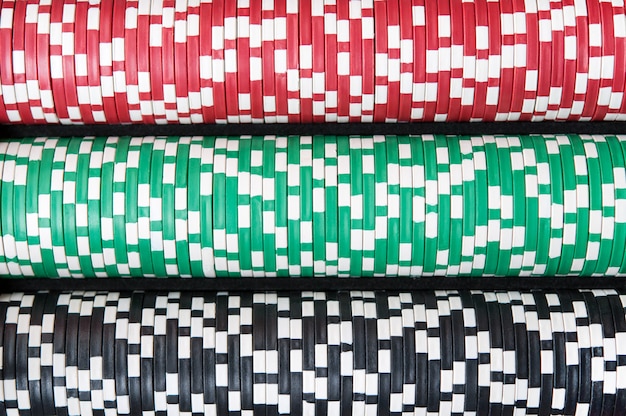 A lot of poker chips lie horizontally, top view.