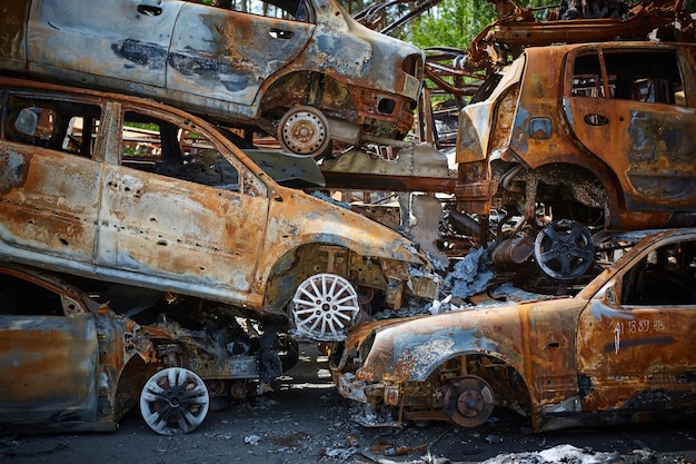 A lot of rusty burnt cars in Irpen after being shot by the Russian military Russia's war against Ukraine Cemetery of destroyed cars of civilians who tried to evacuate from the war zone