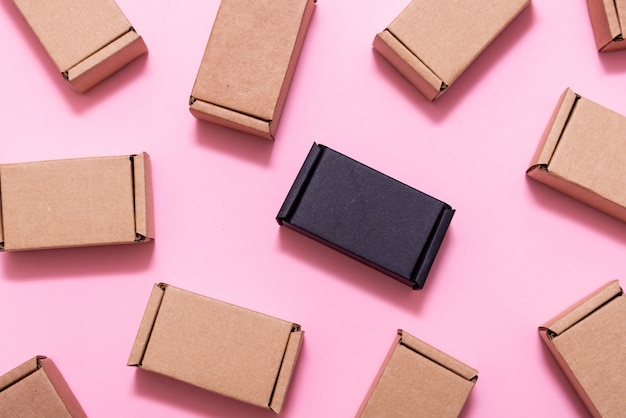 Lot of small cardboard boxes on pink table