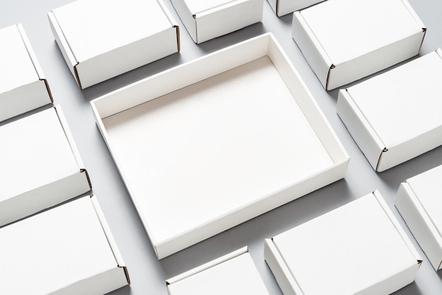 Lot of square carton boxes on grey background