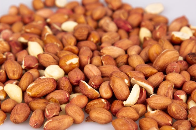 A lot of unpeeled peanuts isolated on a white background\
clipping path full depth of field background image