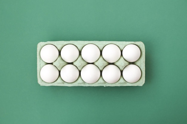 A lot of white chicken eggs on a colorful even and bright background