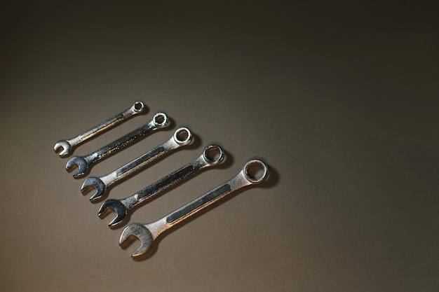 A lot of wrenches on a dark gray background