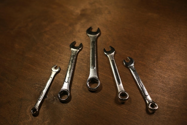 A lot of wrenches on a wooden background