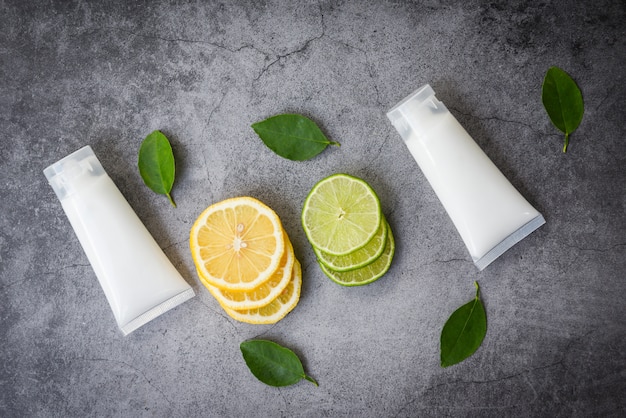 Lotion bottle natural for face and body beauty remedies and organic minimalist lifestyle with lemon lime slice and green leaves herbal formulations 