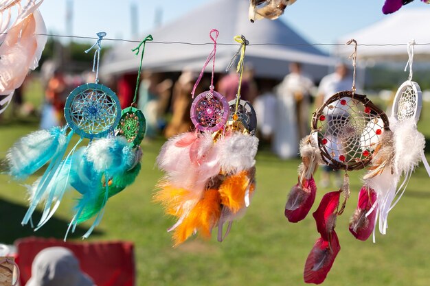 Lots of beautiful dream catchers hanging from the ceiling of a market stall on the street Fair