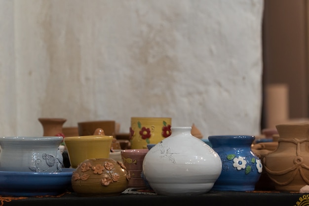 Lots of beautifully decorated clay pots. children's crafts