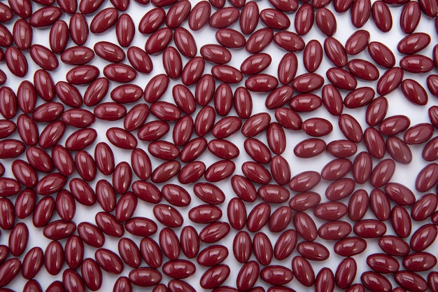 Lots of brown pills as a background on a light table