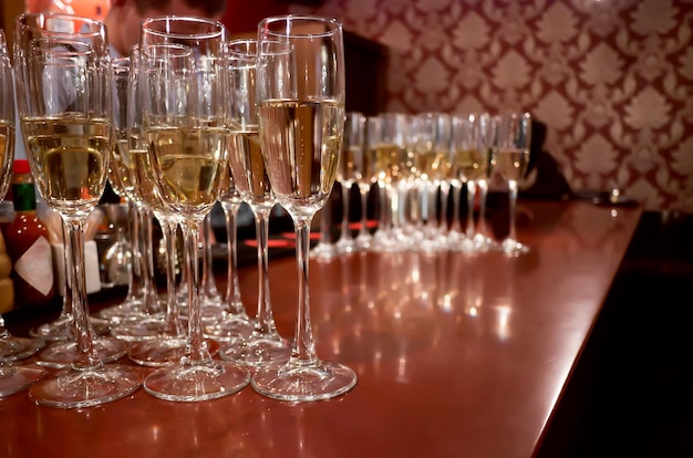 Lots of champagne glasses on the bar table