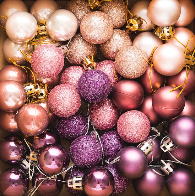 Lots of Christmas tree shiny balls on pink