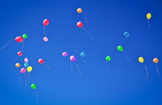 Lots of colorful balloons flying on blue sky