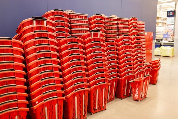 Lots of empty shopping baskets stacked in the supermarket